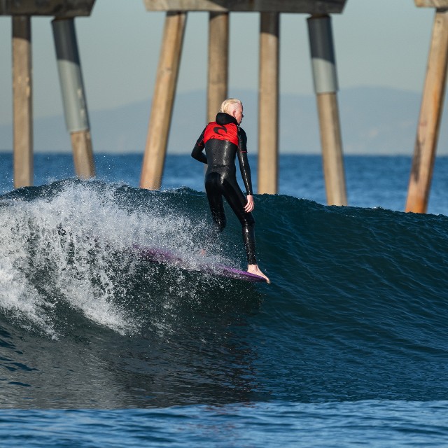 Cormac Obrien longboard surfing hang 5 on a shoulder high left at Hermosa Pier January 2024